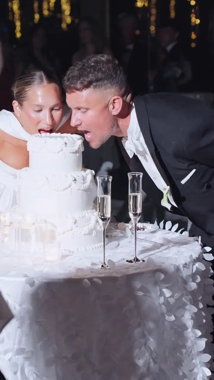 Amy and Loren feeding each other wedding cake