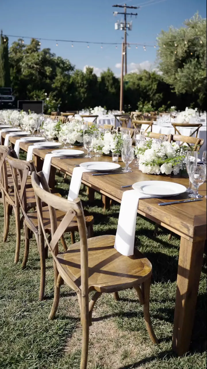 A long banquet table dressed with white florals