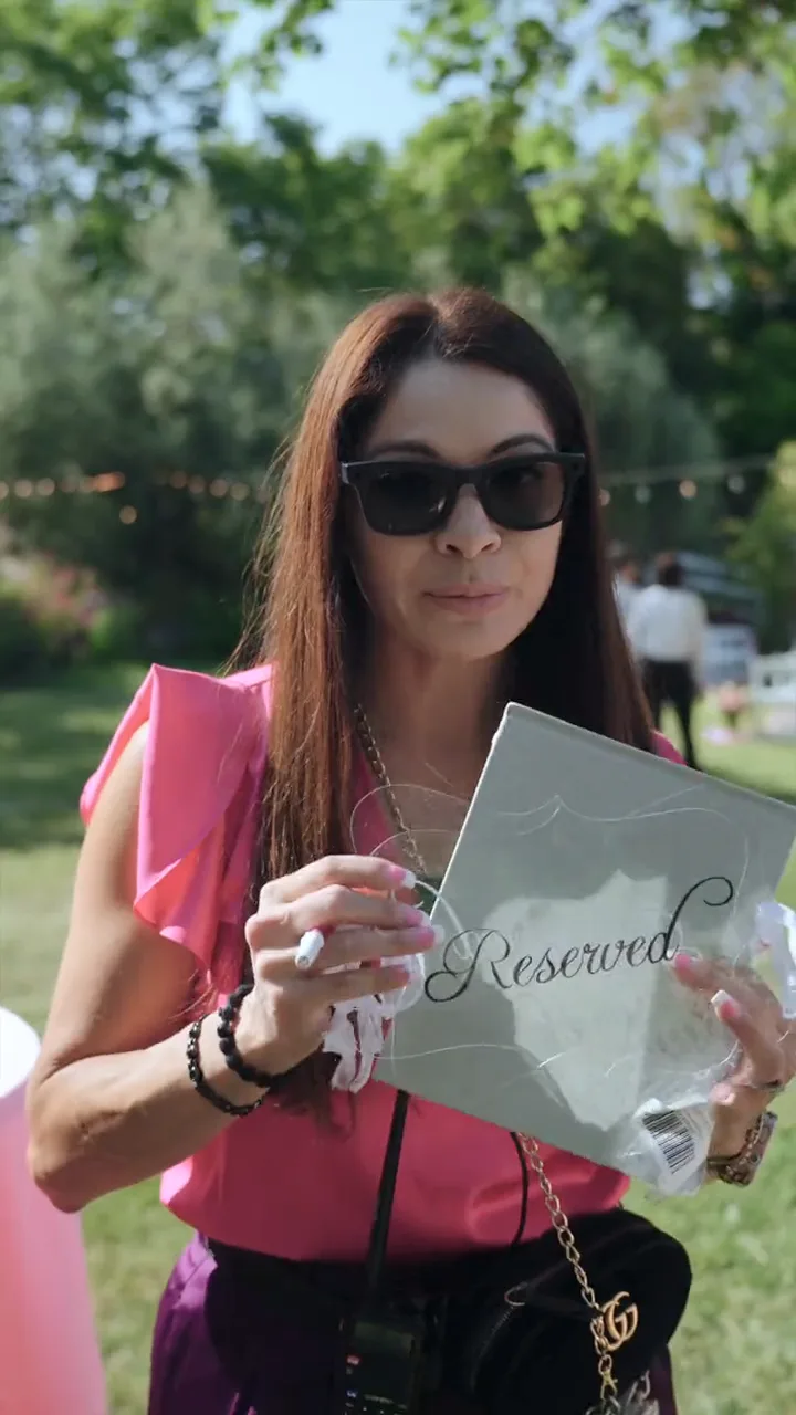 A wedding planner holding a reserved sign