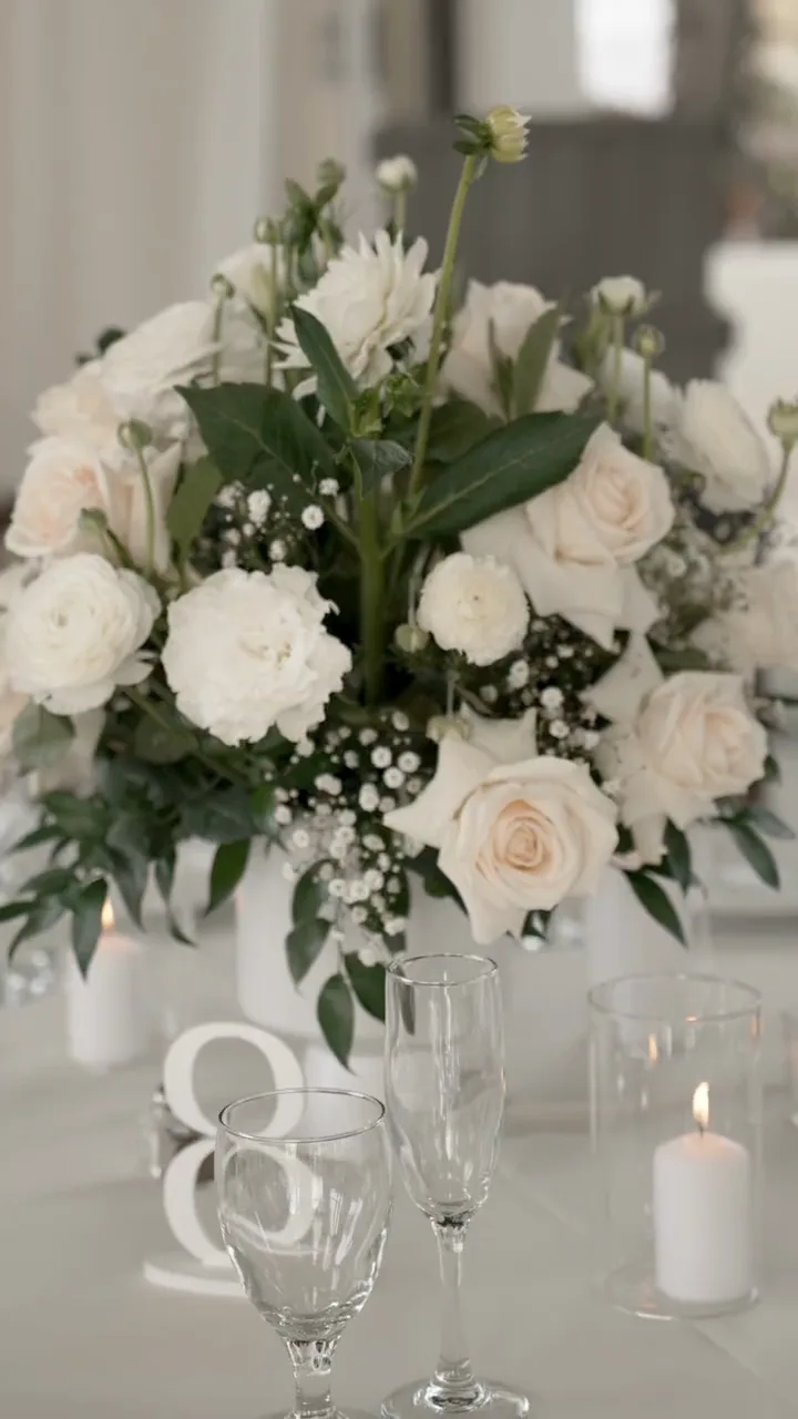 A tall floral centrepiece on a set reception table