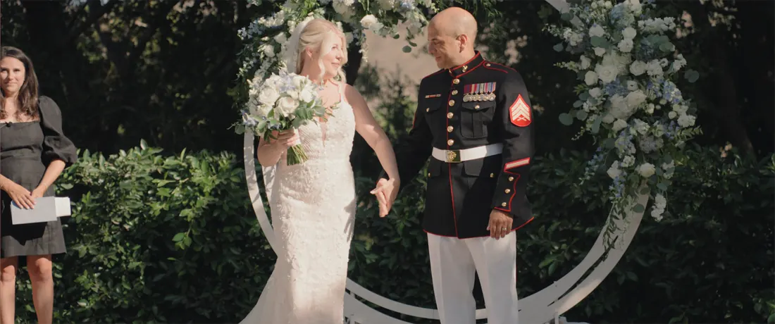 Vows in front of a circular floral arch at Maravilla Gardens
